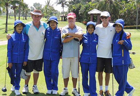 Tim, Mark and Phil with their lovely caddies at Thai Country Club.