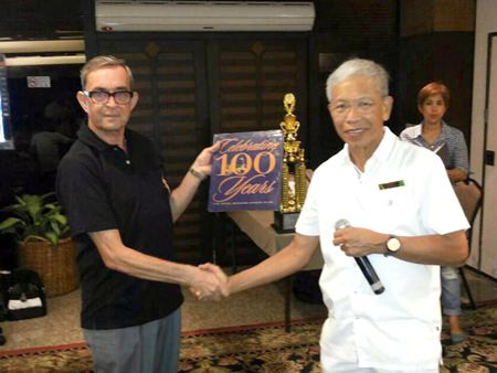 Derek from the Coco Club (left) accepts the RBSC history volume from Ken, the RBSC Lawn Bowls Chairman.
