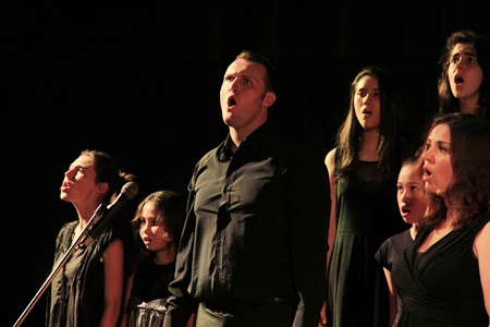 Staff and students in the chorus line of Les Misérables.