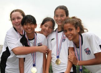 Year 6 girls celebrate their victory in the football competition.