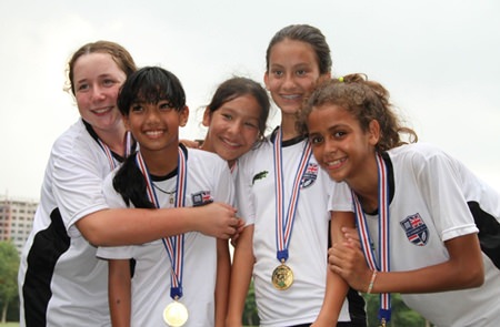 Year 6 girls celebrate their victory in the football competition.