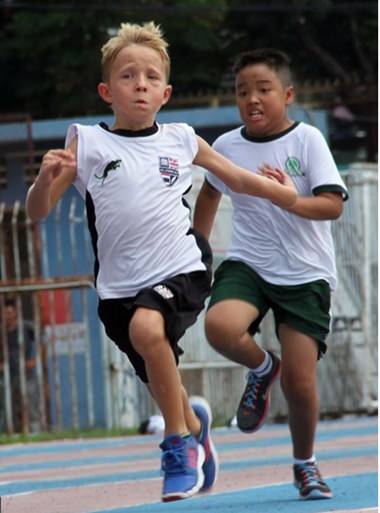Nick from year 3 powers across the finishing line.