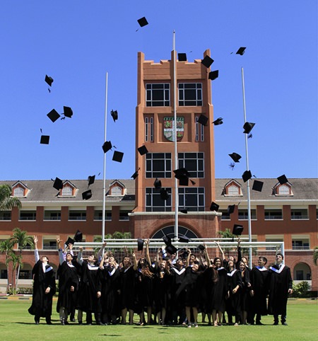 In true graduation tradition, students throw their mortar boards high into the air in celebration.