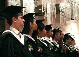 The class of 2014 listen attentively to the speeches in the Hilton Ballroom.