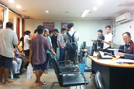 Gamblers are brought in for questioning after police raided illegal gambling dens in Pattaya and Huay Yai.