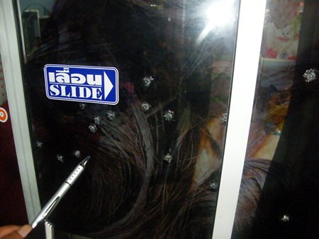 No one was hurt, but the window of this salon were damaged by pellet gun fire.