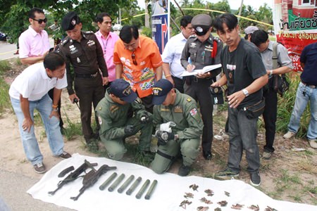 Officials inspect a cache of weapons found in Sattahip.