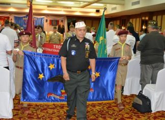 Convention Chairman Al Serrato leads the marching Boy Scouts through the crowd of veterans before the opening ceremony.