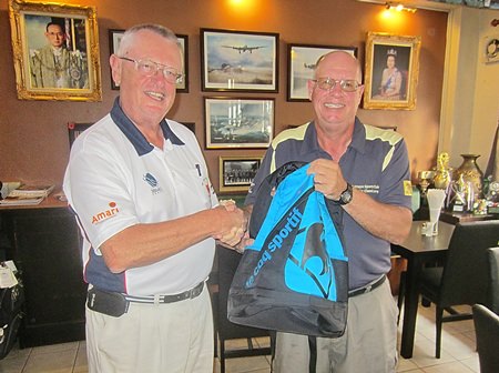 Dick Warberg (left) presents the MBMG Group Golfer of the Month award to Brian Gabe.