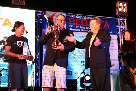A delighted Bill Bremner (centre) receives his AYGP jacket and trophy from Captain Marty Rijkuris (right).