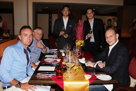 Tomo Kuriyama (left), general manager of the Sheraton Pattaya Resort, poses for a photo with guests before dinner.