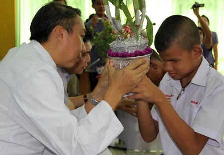 Father Peter accepts a floral gift from one of the blind students.