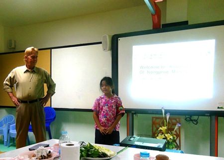 Philip Delaney encourages a shy young lady to speak English.