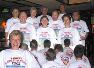 The committee models the 2002 event shirts.