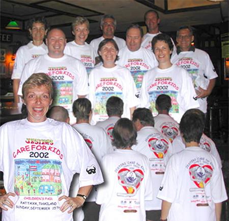 The committee models the 2002 event shirts.