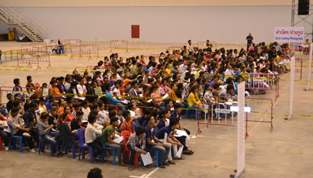 Migrant workers wait for their turn to register and become legal workers in Thailand.