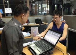 Krit Kanchanaprasan fills out a theft report with police.