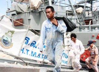 Fearing death, Burmese fishing ‘slaves’ jump overboard in Rayong Khanai and Sew disembark from the HTMS Prabparapak, tied up alongside the HTMS Su Pharin after the latter pulled them from the sea.
