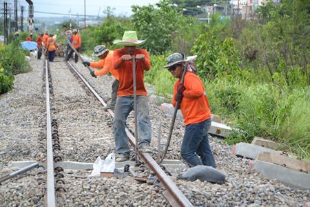 Workers install new concrete railroad ties near the Pattaya train station.