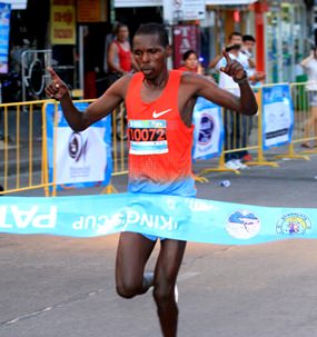 Kenya’s Alex Melly crosses the finish line in a time of 2.25:32 hours to win the 2014 King’s Cup Pattaya Marathon, Sunday, July 27.