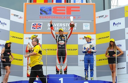 Sandy Stuvik (center) celebrates on the podium after double success at Silverstone.