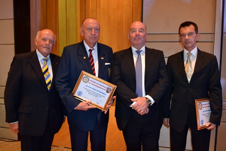 VP Juergen Schlag (left) joins in the lineup as H.E. Rolf Schulze (2nd right) inducts Trutz Fiddikow (2nd left) and Austrian Consul General Rudolf Hofer (right) as honorary members of the Rotary Club Phoenix Pattaya.