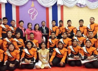 Music teacher Saroj Bunmuang (back row, center) is most proud of the Phothisamphan Phitthayakhan School band winning the HRH Princess Soamsawalee trophy at the 6th Melodeon Music Fair to honor HM the King.