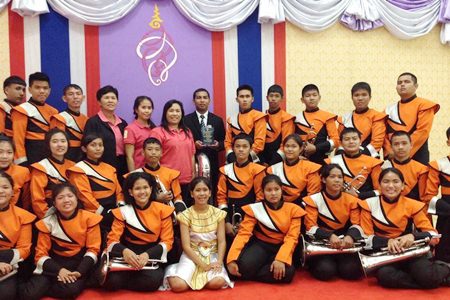 Music teacher Saroj Bunmuang (back row, center) is most proud of the Phothisamphan Phitthayakhan School band winning the HRH Princess Soamsawalee trophy at the 6th Melodeon Music Fair to honor HM the King.