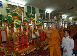 A senior monk at Wat Nok lights candles to commemorate HRH Crown Prince Maha Vajiralongkorn’s birthday July 28.