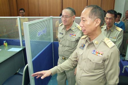 Interior Ministry Permanent Secretary Wiboon Sanguanphong (left) and Chonburi Gov. Khomsan Ekachai (right) tour the Chonburi Operations Center in its temporary office at Chonburi City Hall.
