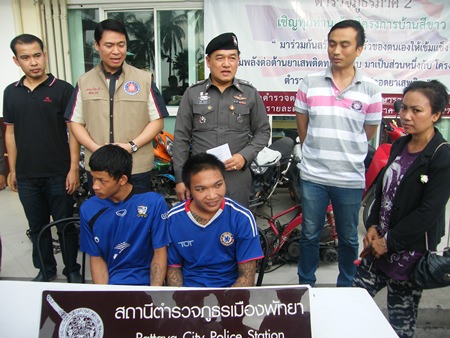 Sutin “Joke” Srisook (seated right) and cohort Patcharapong Uam-urb have been arrested for theft.