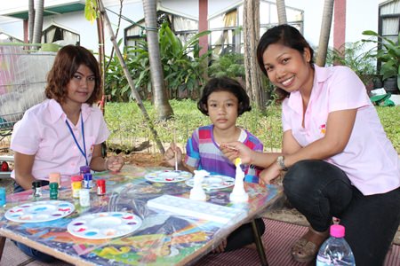“Children young and old” undertake painting activities for charity.