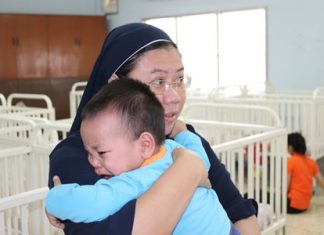 A look inside the Human Help Network Thailand A nanny cares for a young child as if it were her own.