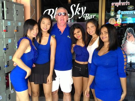 Irish John celebrates his golfing success with the staff at Blue Sky Bar.