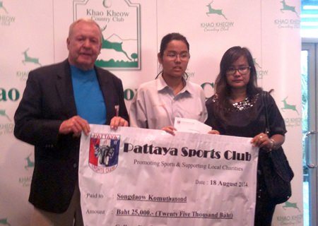 Joe Mooneyham (left), VP Pattaya Sports Club, presents a check to daughter and mother.