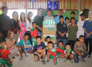 Public officials and business leaders donate medicine and cash to the Anti-Human Trafficking and Child Abuse Center and Baan Jing Jai Orphanage.
