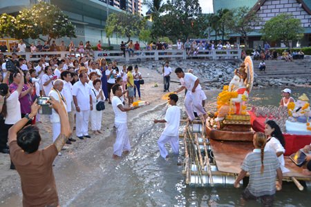 Followers of the Hindu and Buddhist god Ganesha prepare to lower a statue of the “god of success” into the sea at Bali Hai Pier.