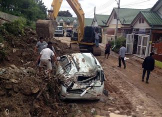 The Sunday night / Monday morning storm was blamed for knocking down a wall and crushing two cars, including this one owned by Prapot Mayom.