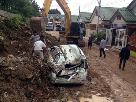 The Sunday night / Monday morning storm was blamed for knocking down a wall and crushing two cars, including this one owned by Prapot Mayom.