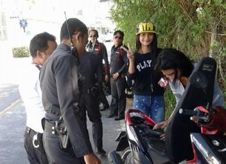 Traffic Police set up a roadblock along Soi Yume, focusing on motorcycle licenses and helmets.