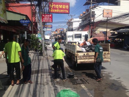 Nongprue Municipal Sanitation officers clean waste from sewage pipes. The back of the lorry is filled with refuse they dug out.