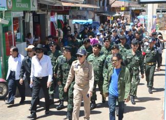 An entourage of government officials, military and local police make their way to inspect Koh Larn’s beaches.
