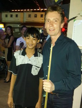 Ice Thiputhai-McArdle (left) played pool against former World Champion snooker player Ken Doherty (right) in a fundraiser at the Pattaya Orphanage for the Father Ray Foundation and beat him one up.