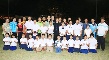 Sponsors, players and excited students gather for a group photo after the tournament.