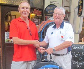 Dick Warberg (right) presents the MBMG golfer of the month award to Doug Maiko.