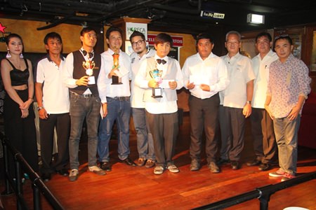 Organizers and winners gather for a group photo after the event. Champion Kitja Khaeikeaw holds the first trophy from the right.