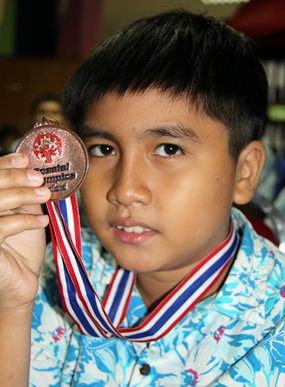 Proudly showing of the silver medal won in the 100m sprint.