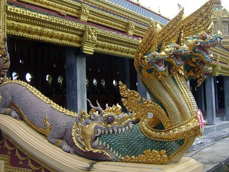 A multi-headed Naga emerges from the mouth of a Makara at Phra Maha Chedi Chai Mongkol, Roi Et (Photo: Pawyilee).