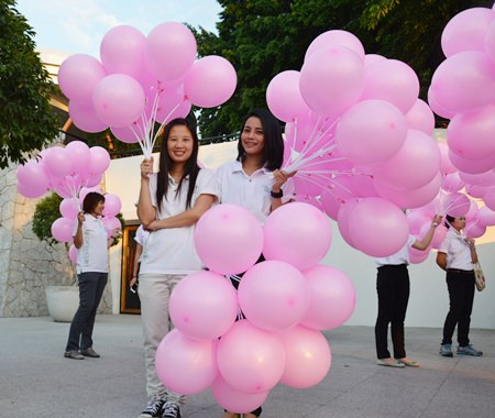 Hard Rock staff hand out pink balloons for the parade.