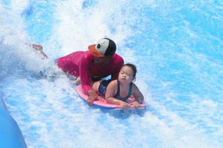 Look Giew learns to surf.